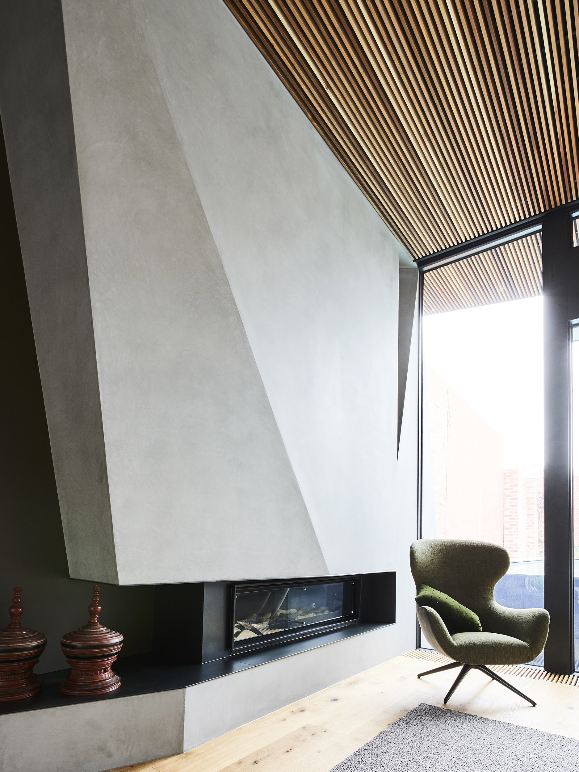 Warm timber ceiling and sculptural fireplace at North Terrace, Clifton Hill